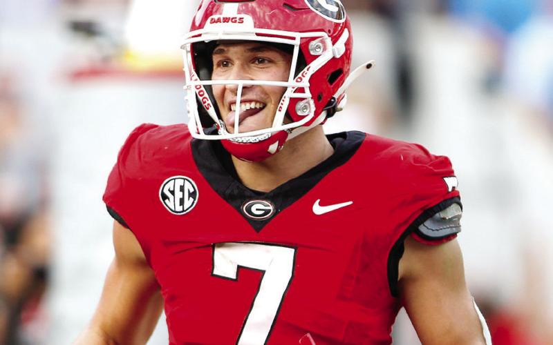 Georgia tight end Lawson Luckie runs off the field with a smile after catching his third touchdown pass of the game. LANCE McCURLEY/Staff