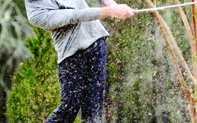A golfer at the inaugural Project Putnam Golf Tourney hits a ball out of a sand trap at URGC in Eatonton. GORDON COLUMBINE/Staff