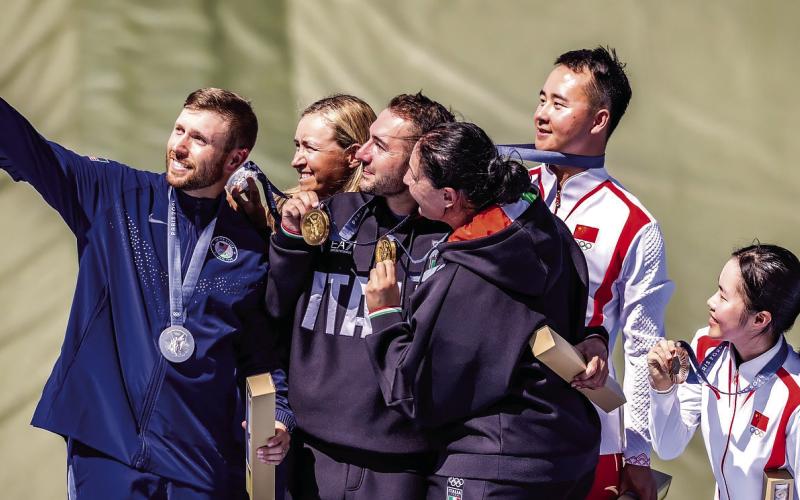Past Eatonton resident Vincent Hancock (left) takes a selfie on the Olympic podium in France alongside his silver medalist partner Austen Smith (second from left) and the gold and bronze medal-winning pairs from Italy and China, respectively, in mixed team skeet shooting. Courtesy USA Shooting