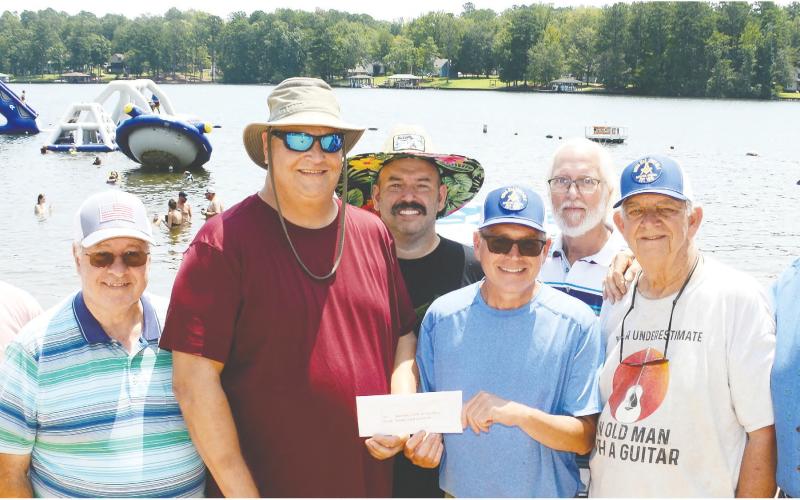 Masonic Home of Georgia Director of Home Life Chris Babcock (third from left) is surrounded by members of Eatonton's Rising Star Lodge #4 as they present a check destined to pay for things like extracurricular sports, prom clothes and transportation, or other school-related extras for the Home's current residents. IAN TOCHER/Staff