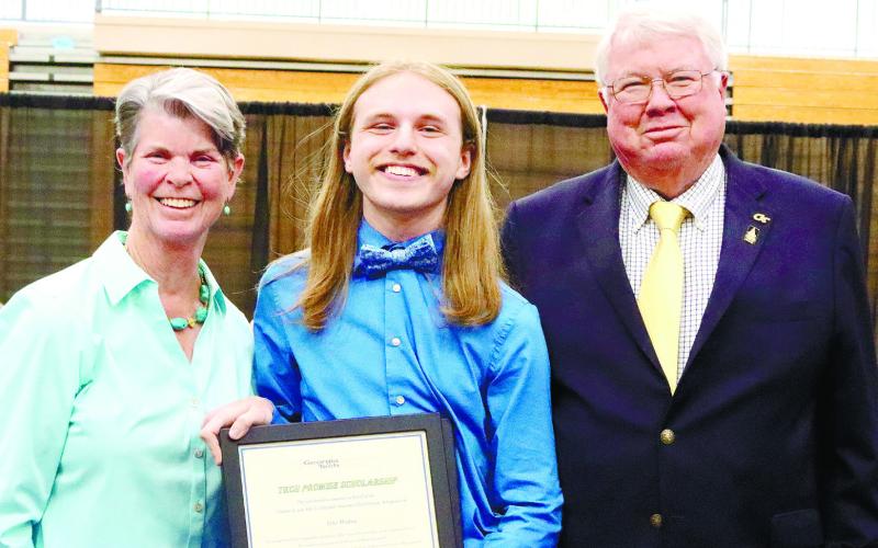 Alla Campbell, Tyler Wallace and Charles Campbell pose with the scholarship. CONTRIBUTED