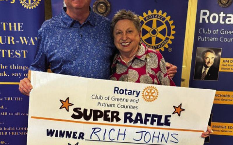 Rotary Raffle Week 38 winner Rich Johns accepted from Rotarian Micki Tanner his prize of a $300 Home Depot gift card, sponsored by ProSouth Electric. CONTRIBUTED