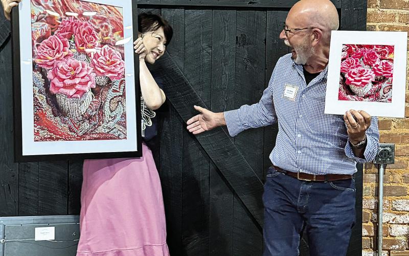 Artist Leslie Guo and photographer Lee Manis share a laugh over their contributions, both titled “Petite Roses.” CONTRIBUTED