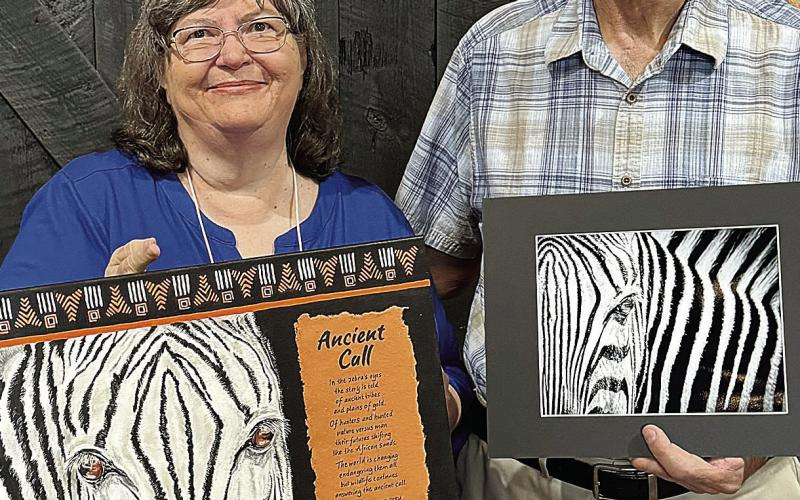 Artist Barbara Lewis presents “Ancient Call” beside Greg Miller with his “Zebra’s Eye” photograph. CONTRIBUTED