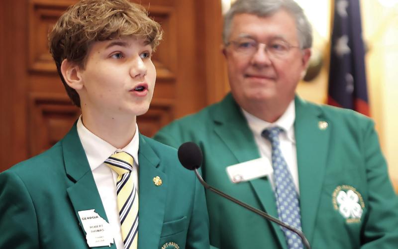 Putnam County 4-H member and Georgia 4-H State Board President Robert Thomas (left) addressed the Georgia Senate and Georgia House of Representatives last Thursday in Atlanta, during Georgia 4-H Day at the Capitol. The man beside him is Rep. Rick Jasperse, of Jasper, who worked as an extension agent before his election. CONTRIBUTED