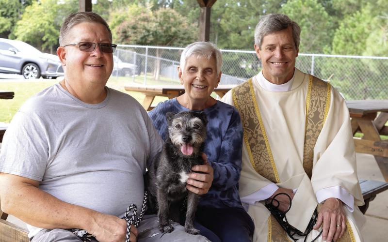 Tim and Pat Winslow with their Leo sit with Rev. Pond. LEIGH LOFGREN/Staff
