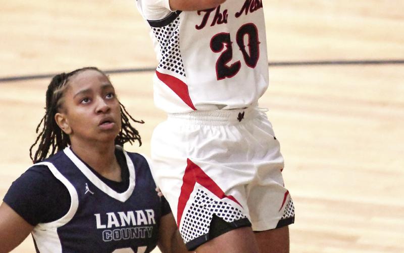 Putnam County freshman point guard Jaydah Baker (20) goes up for a layup over a Lamar County defender in a 70-56 win over the Lady Trojans on Jan. 28. Baker led the Lady War Eagles with 24 points in the win. IAN TOCHER/Staff