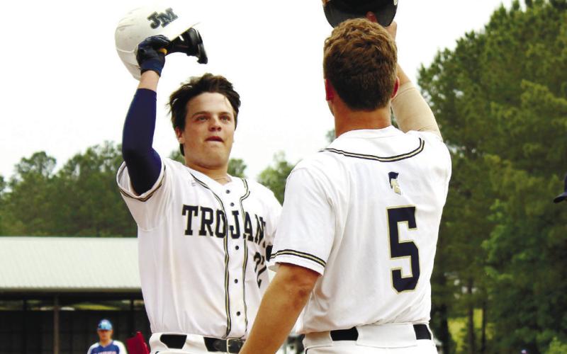 JMA’s Briggs Eady (5) celebrates with Brady Rollins (22) after hitting a home run last Friday against Heritage Academy. TREY NORRIS/Staff