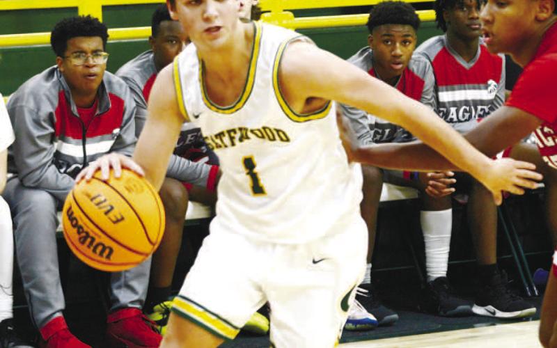 Jackson Morris (1) drives the lane against a YACS defender. IAN TOCHER/Staff