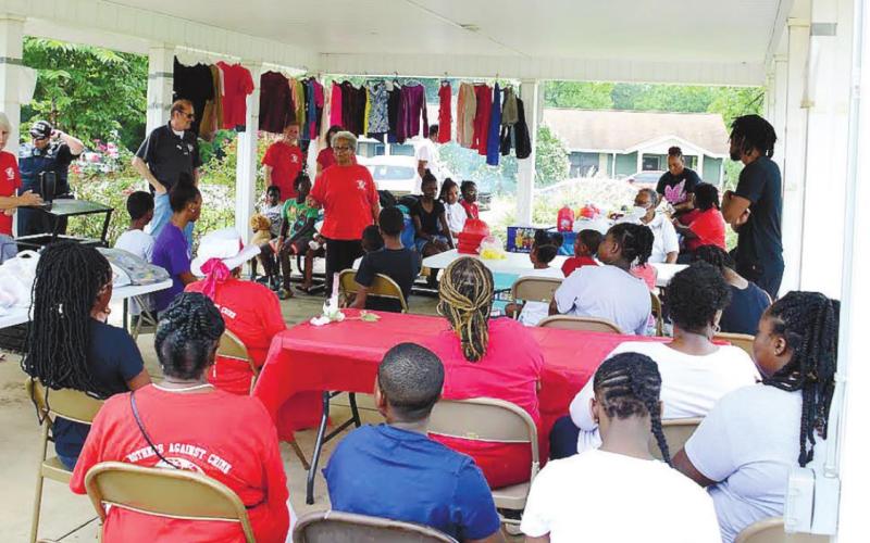 Georgia Benjamin-Smith of Mothers Against Crime addresses the crowd July 30, at the Montgomery Homes Pavilion. IAN TOCHER/Staff