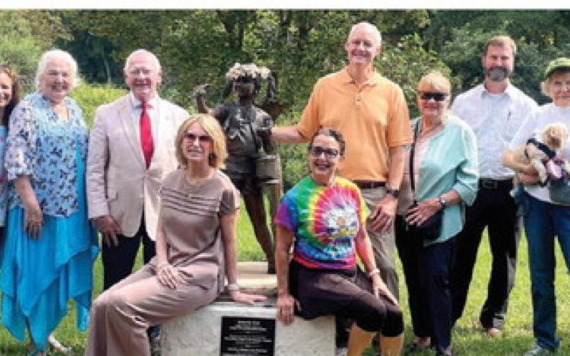 Butterflies &amp;amp; Blooms in the Briar Patch habitat founder Virginia Linch (far right), and the BBBP habitat’s supporters and friends gather around the “Butterfly Girl” to commemorate the reveal of the new addition at the habitat. LYNN HOBBS/Staff