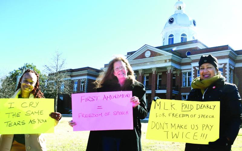 Karen Garrett (right) organized a small but heartfelt demonstration Monday morning in Martin Luther King Jr.’s memory on the Putnam County Courthouse lawn in downtown Eatonton. IAN TOCHER/Staff
