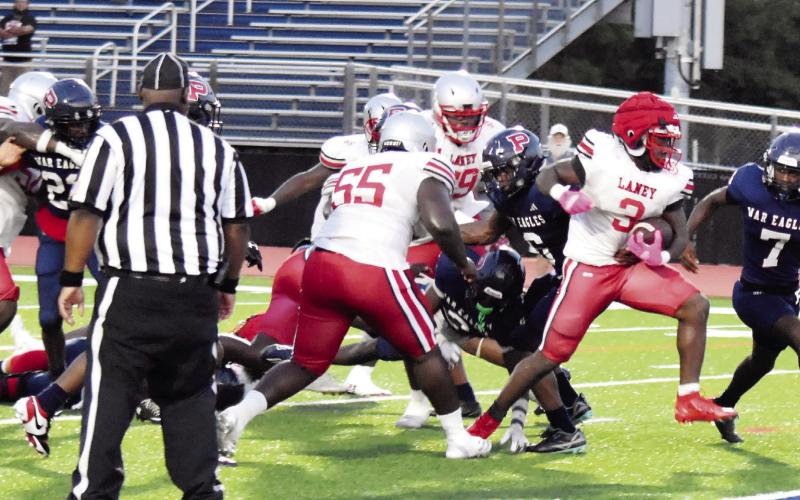 Laney’s Matthew White fights his way past Putnam defenders as he marches his way into the end zone. T. MICHAEL STONE/Staff