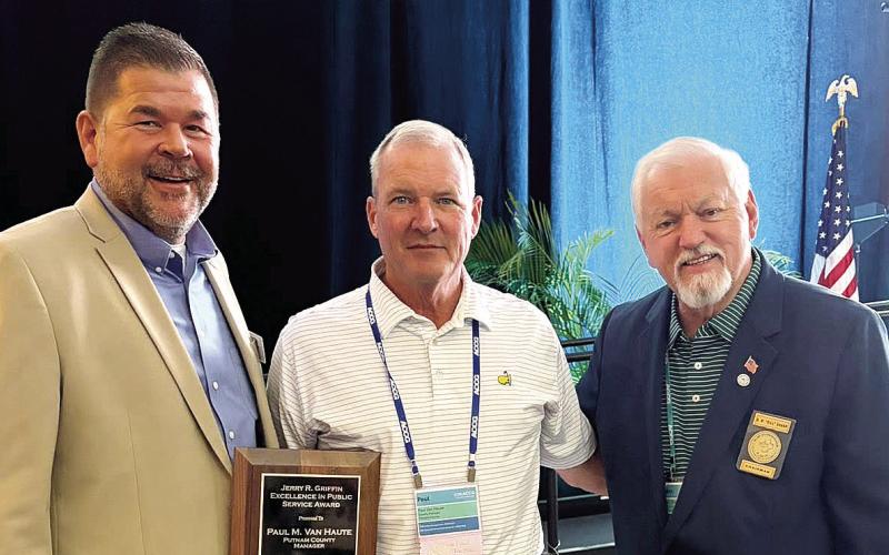 Putnam County District 1 Commissioner Tom McElhenney (left) and County Chairman Bill Sharp congratulate County Manager Paul Van Haute (center), who received the Jerry R. Griffin Excellence in Public Service Award on Saturday in Savannah. CONTRIBUTED