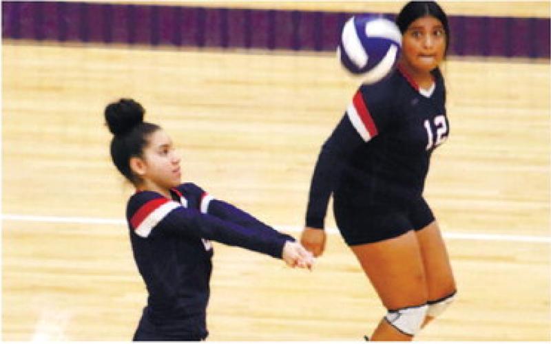 Priscilla Sepulveda places a set for Regina Espin (12).