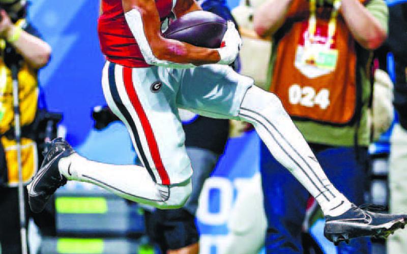 Georgia wide receiver Arian Smith (11) scores on a 76-yard touchdown pass from Stetson Bennett. TONY WALSH/UGA Athletics