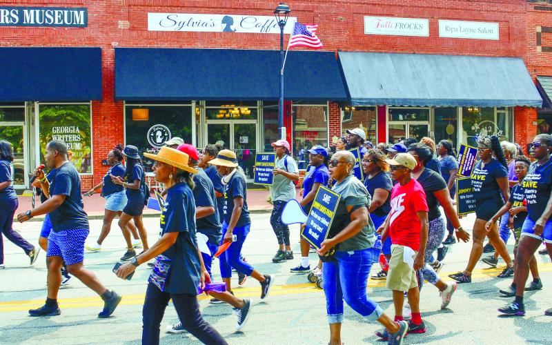 Carrying signs and wearing t-shirts emblazoned with Save Jimmy Davis Park, more than 200 people marched up Eatonton’s Jefferson Avenue.