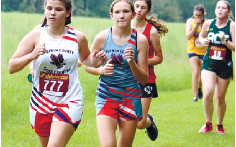 Caroline Thomas (777) runs alongside pacesetter and top PCMS girl Emma Patrick. ARELLA CASH/Staff