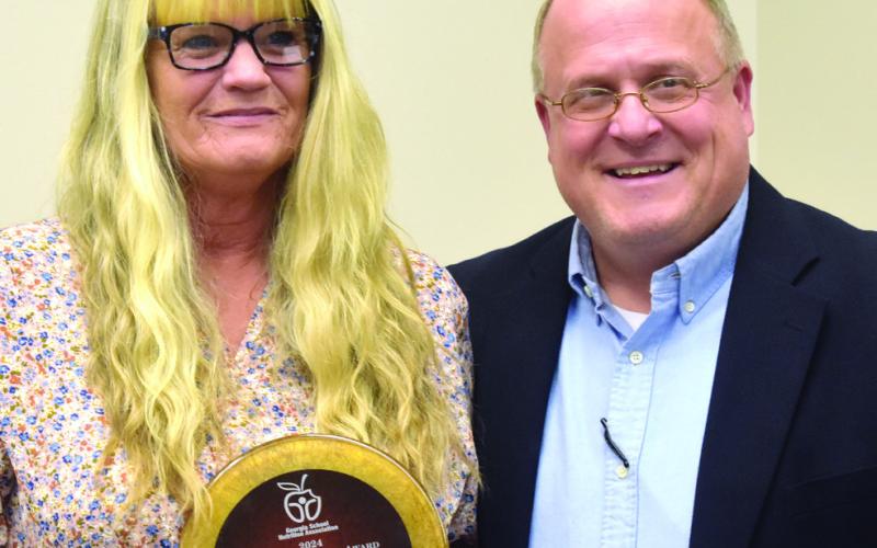 Assistant Superintendent Scott Sauls recognizes Putnam County Nutrition Director Teena Carr for her achievements throughout the year. BAILEY MCCULLY/Staff