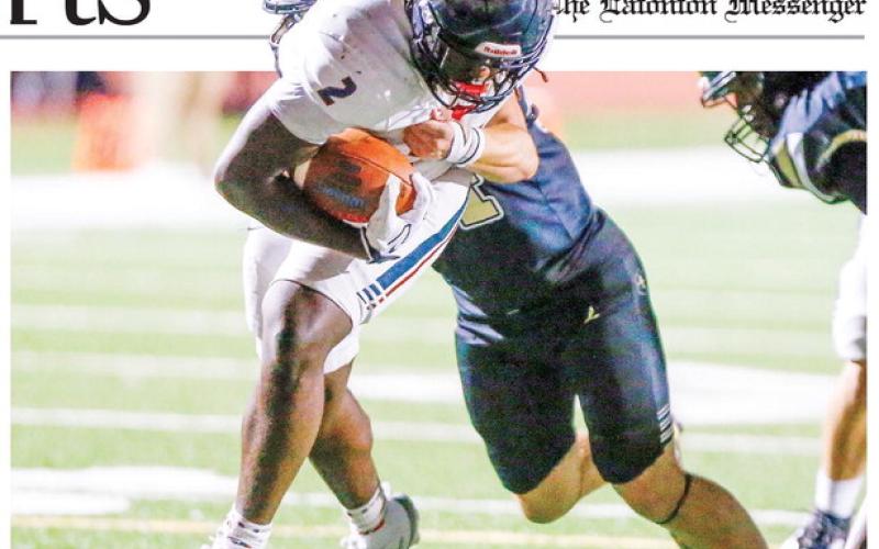 Putnam County junior running back Kumari Thomas (2) shrugs off a Greene County defender as he crosses the goal line for his second touchdown of the game. LANCE McCURLEY/Staff