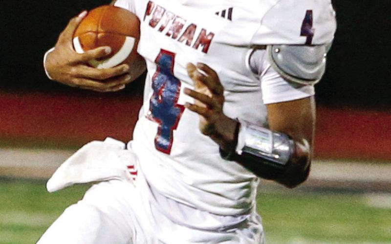 Putnam County junior quarterback Caleb Reeves (4) scrambles out of the pocket. LANCE McCURLEY/Staff