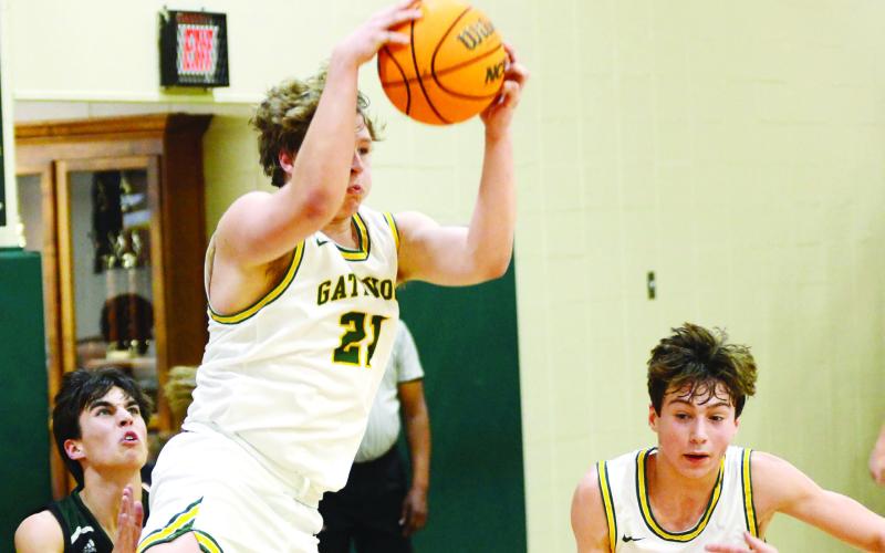 Gators coach Don Keiser singled out “big man” Trey Wiggins (21) for his physical play and scoring touch in a 71-36 win over Westfield last Saturday night in Eatonton. Meanwhile, Gatewood’s top scorer Matt Allen (12) continued to rack up points, scoring 31 for the home team. IAN TOCHER/Staff