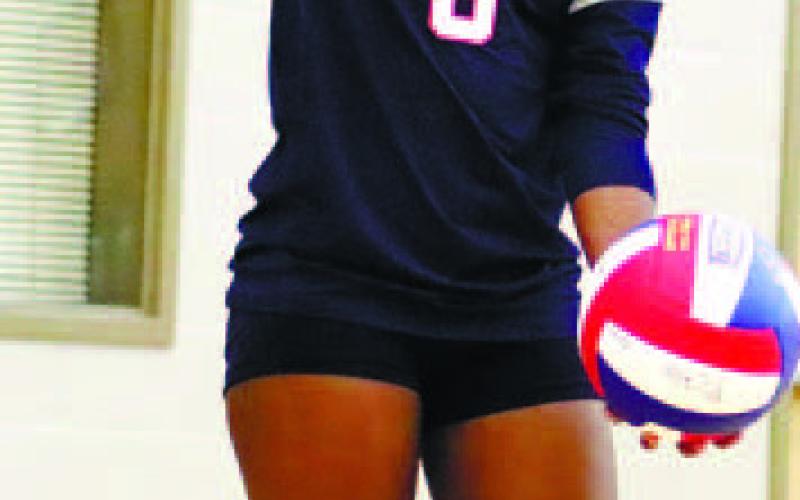 Bernicia Harris (6) serves the game point .