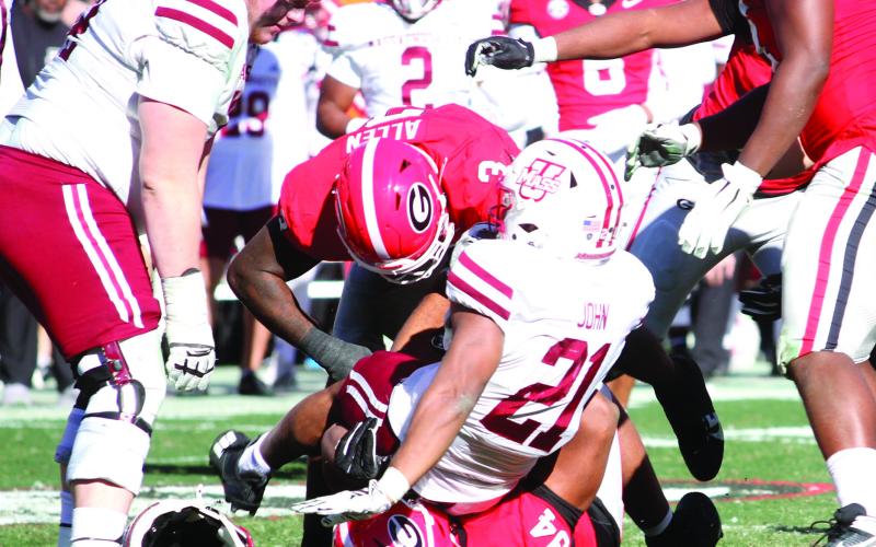 Georgia linebacker CJ Allen (3) and defensive lineman Xzavier McLeod (94) swarm Massachusetts running back Jalen John (21). BRAD HARRISON/Staff