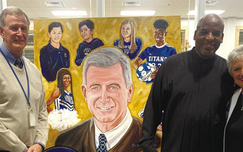 Artist James Threalkill (right) gifts LOA CEO Dr. Ortho Tucker a mural of Tucker for the new fine arts building. CONTRIBUTED