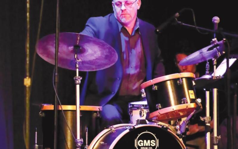 Bandleader and drummer Justin Varnes performs.