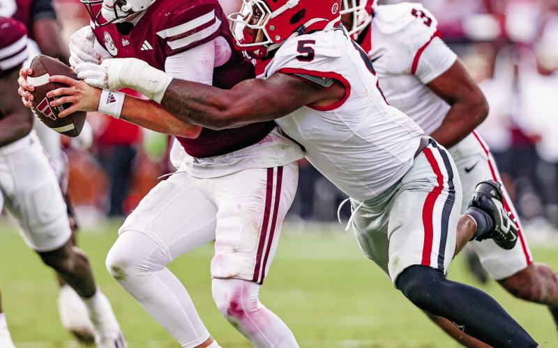 Georgia inside linebacker Raylen Wilson (5) attempts to bring Mississippi State quarterback Blake Shapen to the ground. Courtesy of UGA Athletics