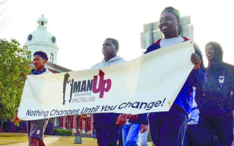 Students from Putnam County High School and members of the MAN UP Mentoring group led the procession away from the county courthouse