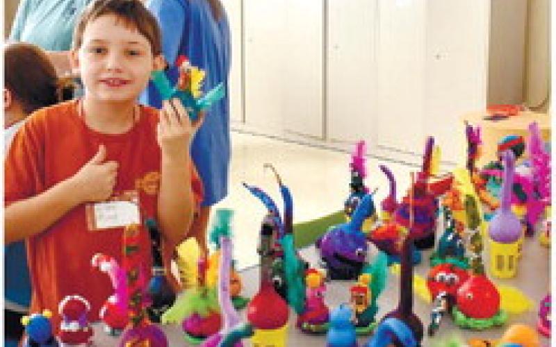 Liam Moon shows off his colorfully decorated gourd. LENA HENSLEY/Staff