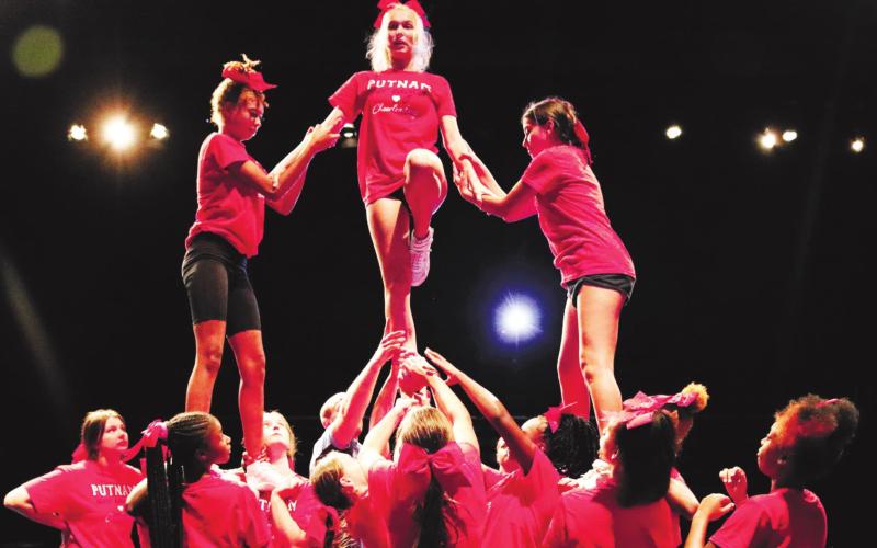 The Lady Eagles competition cheer team practices pyramid movement.
