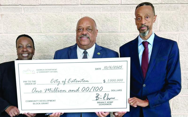 Eatonton Mayor John Reid (center) was joined by his wife and City Councilmember for Ward 3 Janie Reid, and Ward 2 Councilmember James Gorley in accepting a $1 million Community Development Block Grant for flood mitigation work on the south side of the city. CONTRIBUTED