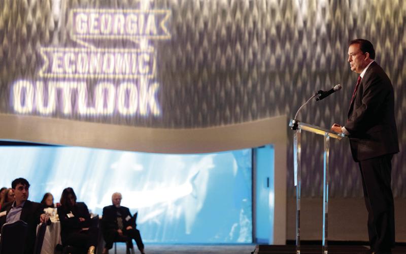 Dean Ben Ayers delivers the state of the Georgia economy during the Georgia Economic Outlook presented the Terry College of Business at the Georgia Aquarium on Friday. PHOTO BY RICHARD HAMM/UGA