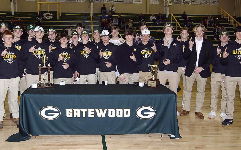 Members of the Gatewood baseball team were introduced during halftime Jan. 23 at the Gators basketball game as each was officially presented their 2023 GIAA Class AA state championship rings by head coach Brandon Moss (far right). Several players who have since graduated from Gatewood’s high school returned from various colleges to Eatonton for the ceremony and the team received an enthusiastic welcome from the hoops crowd. IAN TOCHER/Staff