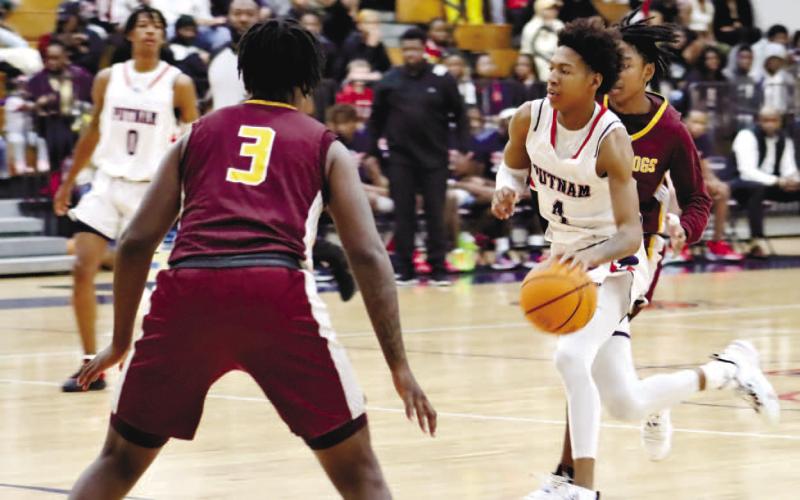 Keyni Crawford (4) brings the ball up the court against Hancock Central. ARELLA CASH/Staff