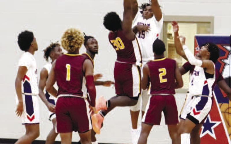 Micheal Morris (15) goes up for a block. ARELLA CASH/Staff
