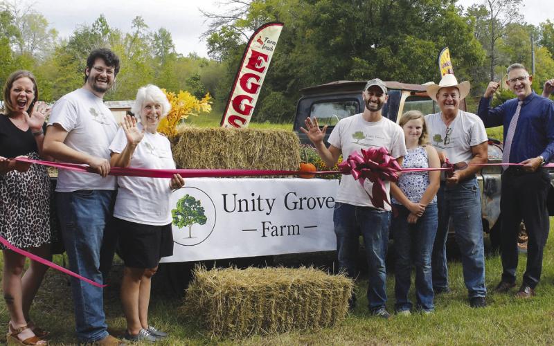 Unity Grove Farm owners Andrea Perkins (fourth from left) and Elliott Perkins (in cowboy hat), welcomed just a few friends and family members to a ribbon cutting last Saturday, hosted by the Eatonton-Putnam Chamber of Commerce.