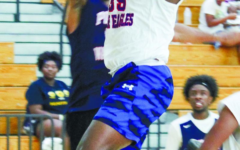 Deon McBride (class of '15) goes up for a contested layup against Trevalance Farley (class of 2009). TREY NORRIS/Staff