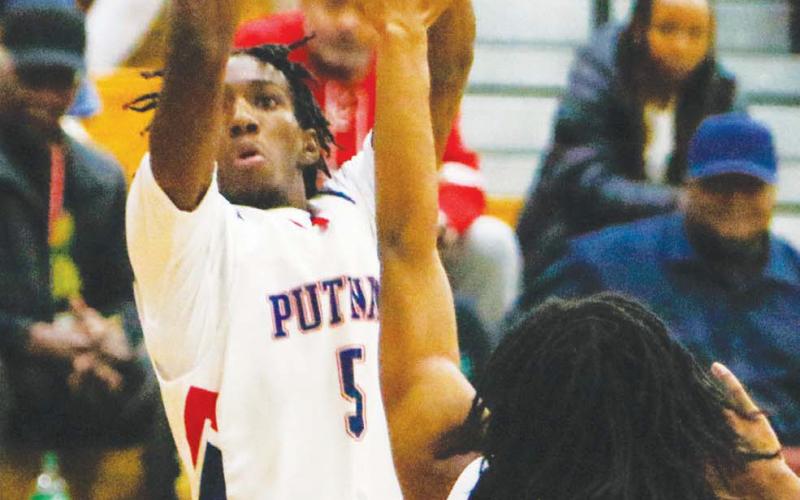 Putnam junior Jmari Greene attempts a 3-pointer from the top of the key. LANCE McCURLEY/Staff