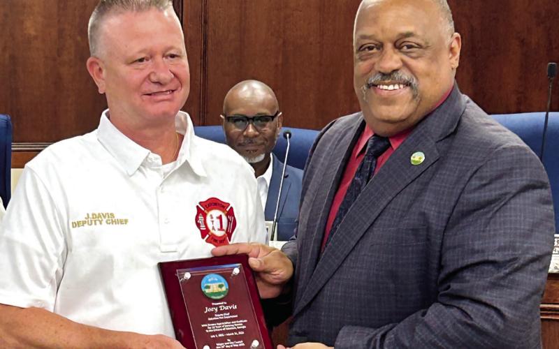 Joey “Superman” Davis (left) receives his retirement plaque from Eatonton Mayor John Reid. CONTRIBUTED
