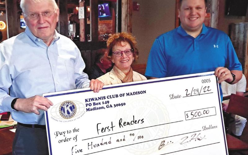 Babs Johnston of Ferst Readers accepts a check for $500 from Kiwanis President Brittain Hunt and Dr. Wayne Myers. CONTRIBUTED