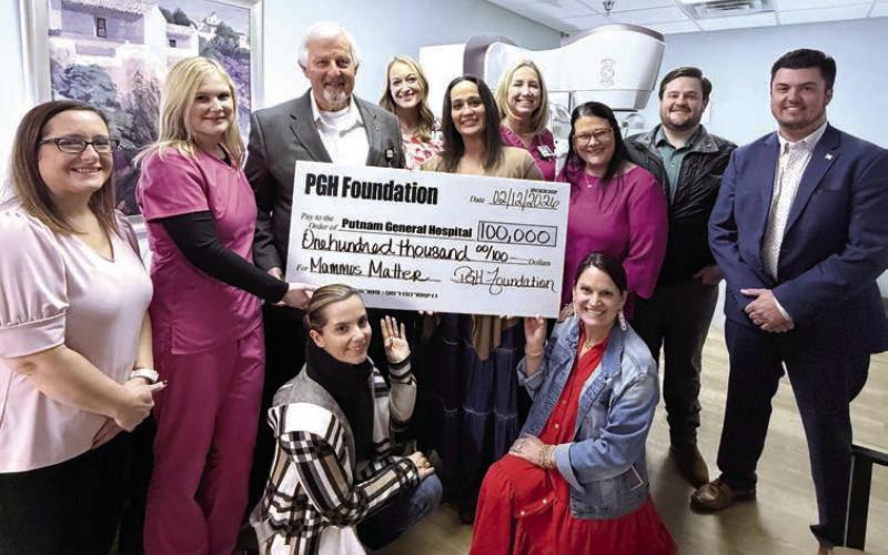 Putnam General Hospital leaders and staff pose earlier this month with a sizable contribution from the PGH Foundation on behalf of local donors. SKYLA MORRIS/Staff