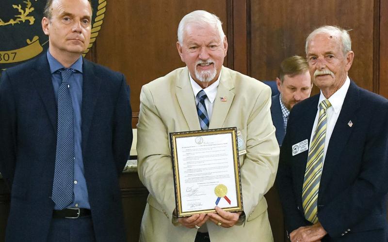 County Chairman Bill Sharp displays a proclamation declaring September as “National Recovery Month,” flanked by Commissioners Richard Garrett (left) and Dr. Stephen Hersey. IAN TOCHER/Staff