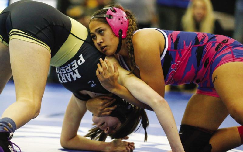 Michelle Hernandez tries to put her opponent in a headlock during a match at the traditionals sectionals duals at Locust Grove Feb. 4.