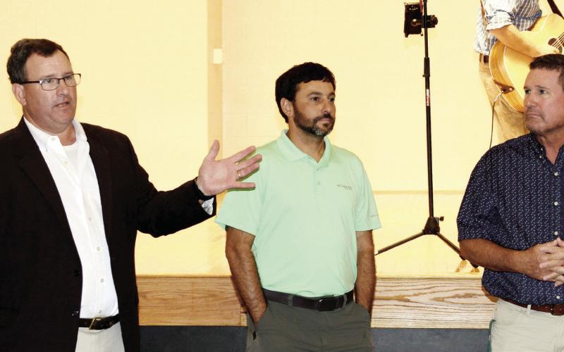 L-R: Gatewood alum and City of Eatonton attorney Jeff Huskins, Gatewood board member Jacob Fried, and Head of School Jeff Decker each addressed the crowd in the auditorium of the new Gatewood High School. (IAN TOCHER/Staff)