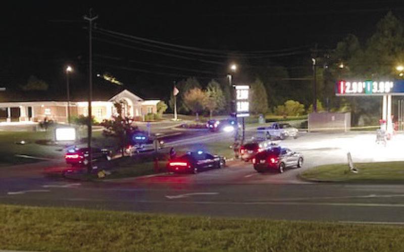 Law enforcement officers set up a perimeter around a scene where suspects were seen running away behind Murphy USA in Milledgeville Saturday morning. JEFF LYLE/Staff