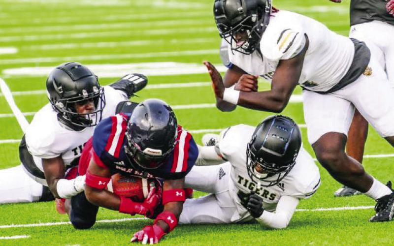 A Greene County ball carrier tries to advance forward as a Putnam County defender is taking him down during last year’s scrimmage. (FILE PHOTO)